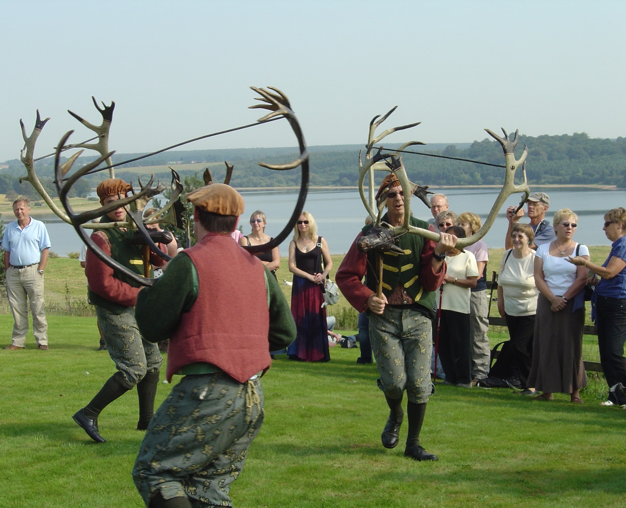 Horn dancers with reindeer antlers on the road above Blithfield Reservoir