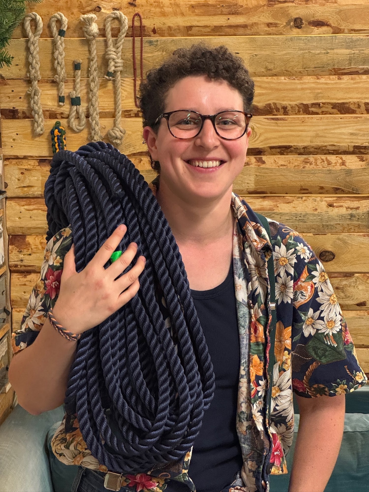 Gem Bowes smiling with a coil of navy rope over her shoulder