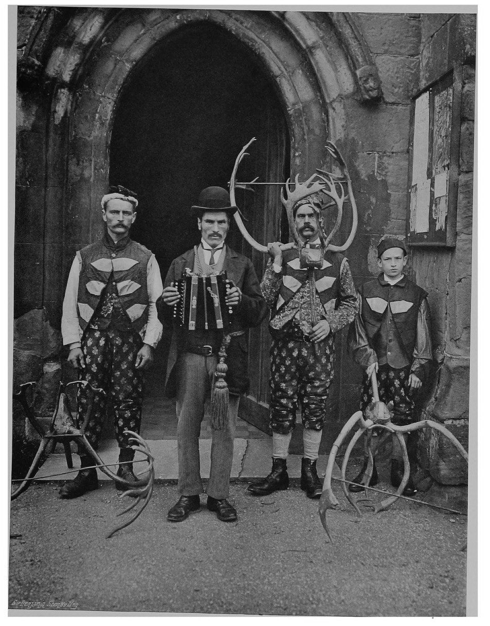 Three horn dancers and the accordion player at Abbots Bromley, photographed in 1899